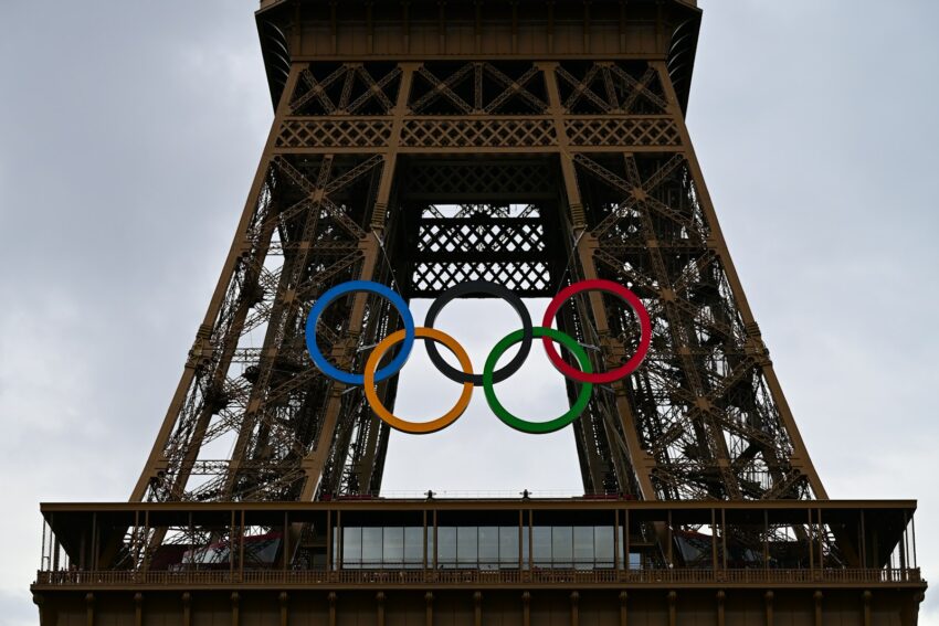 The olympic rings are on top of the eiffel tower