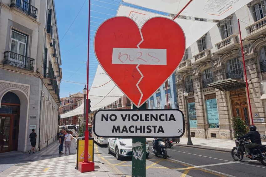 A street sign with a broken heart on it