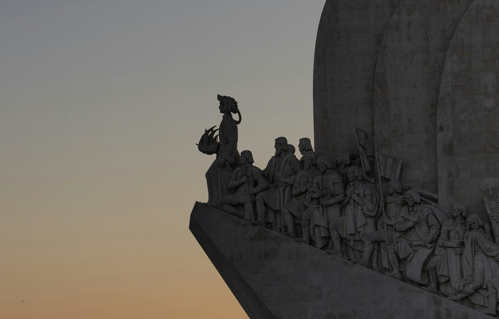 A large monument with a clock on top of it