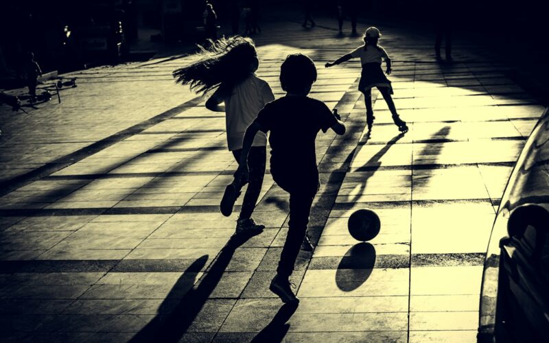a group of young children playing a game of soccer