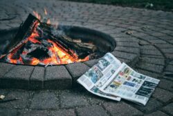 a fire pit with money and a fire in it