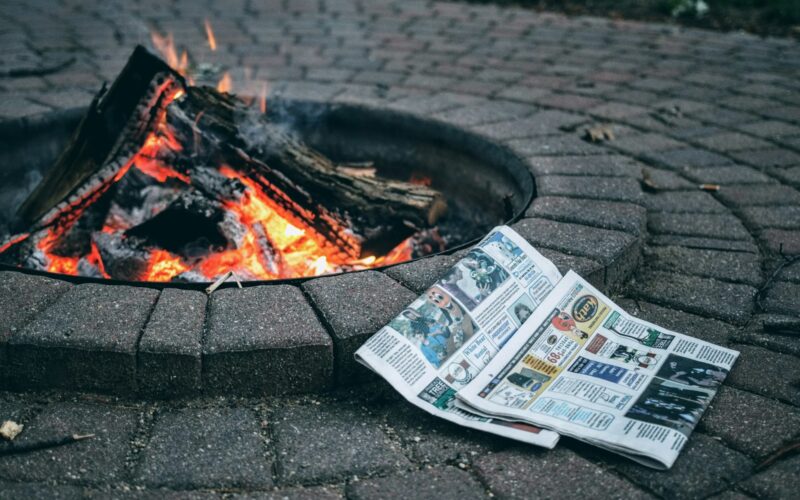 a fire pit with money and a fire in it