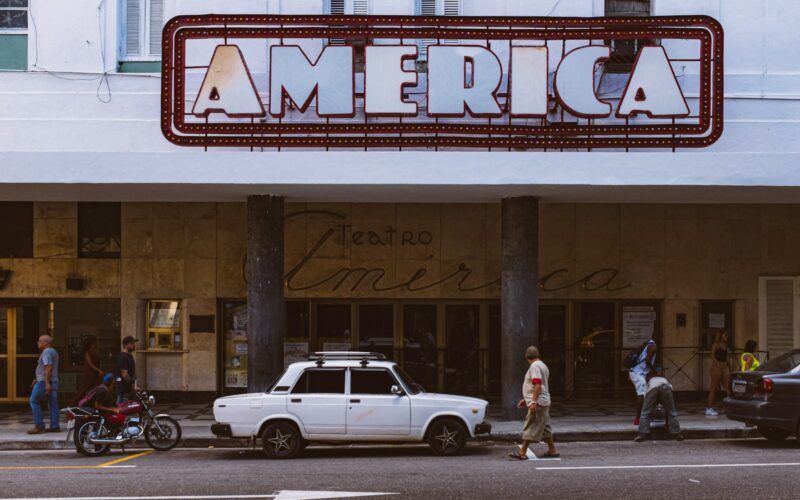 white sedan parked beside white sedan during daytime