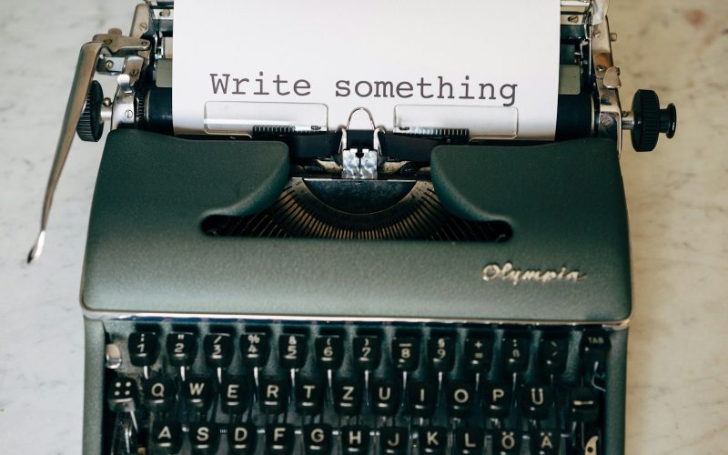 black and white typewriter on green table