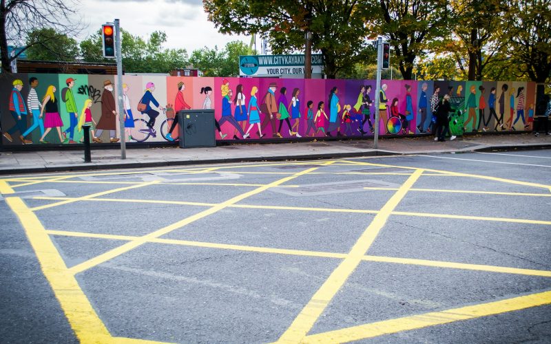 purple and white graffiti on wall
