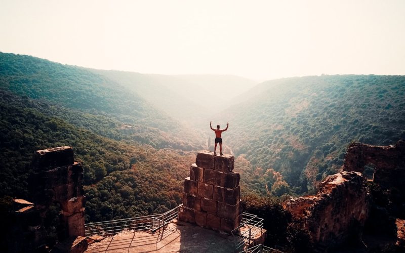 person standing on brown concrete building during daytime